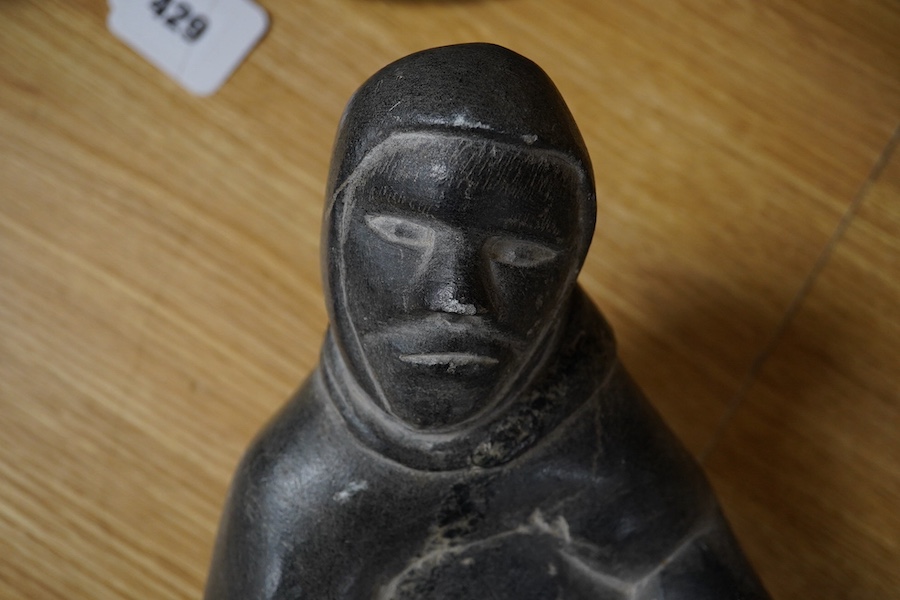 A large Inuit figurative carving, the base signed JOSHPIE, 40cm deep, 20cm wide. Condition - small chip to foot, nose of figure and lip of face.